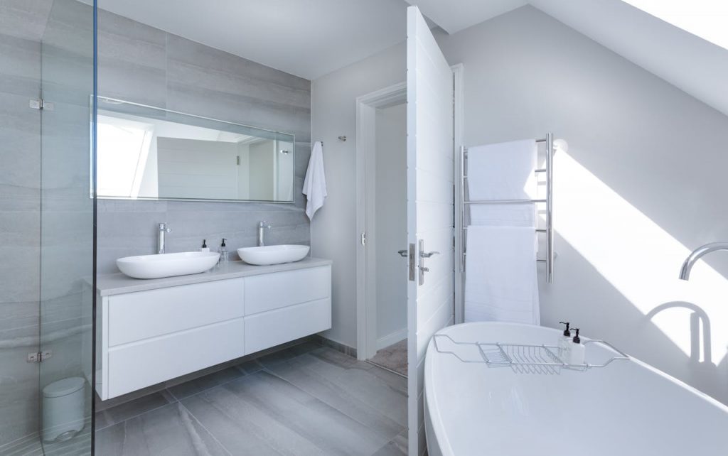 pexels photo 1454804 Sleek contemporary bathroom with bathtub and twin sinks, showcasing minimalist design and luxury.