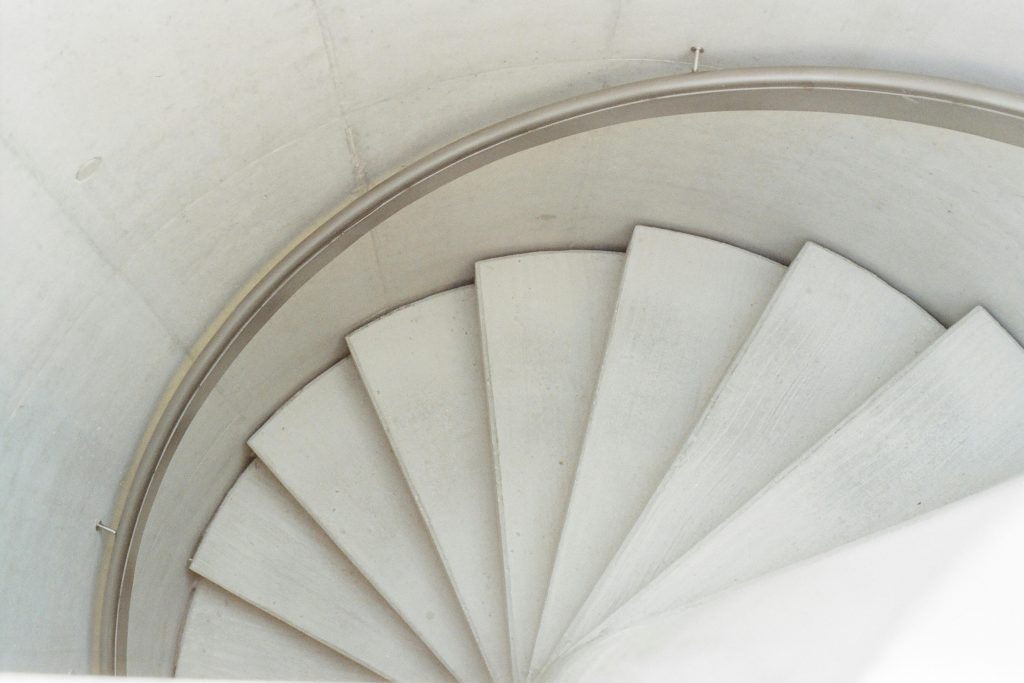 pexels photo 3427031 3427031 A high-angle view of a minimalist concrete spiral staircase highlighting architectural beauty.